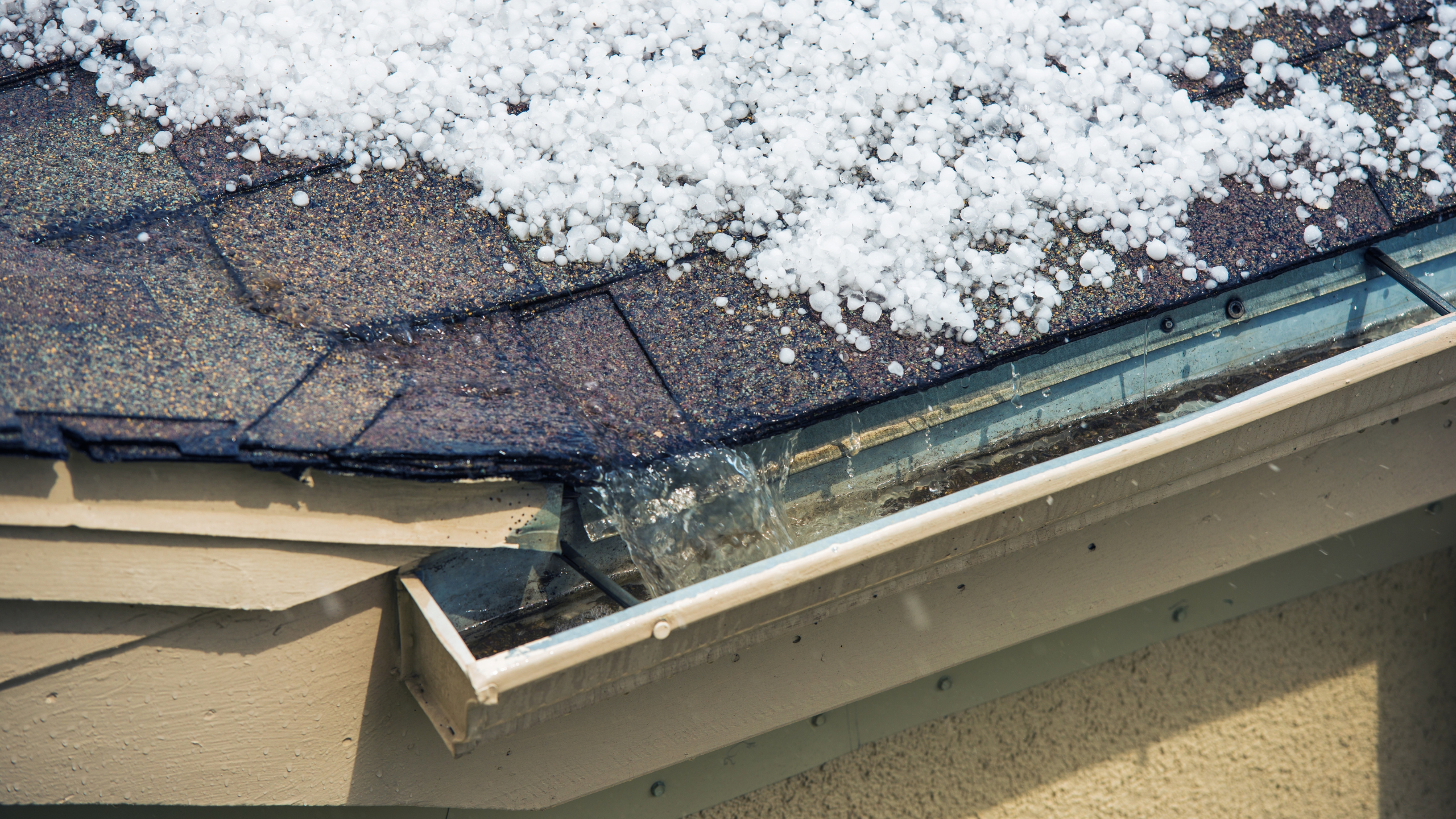 "Snow buildup in residential gutter causing drainage issues"